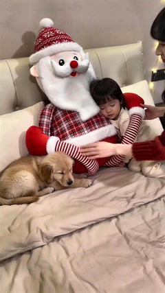 Toddler and puppy cuddled up with Cuddle Santa